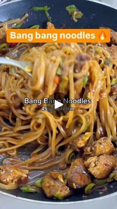 a pan filled with noodles, meat and vegetables