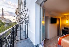 a bedroom with a balcony overlooking the eiffel tower