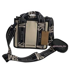 Tik Tok Viral Steve Madden Bwebber Canvas Crossbody Bag , Hard To Find Bag Steve Madden Bwebber Crossbody Purse Steve Madden Tiktok Viral Bag Brand New, With Tags 100% Authentic Color: Black / Tan Approximately : 8" Wide, 7" Tall, 4 Deep Crossbody With Detachable Guitar Strap Flap Snap Closure And Zipper Airpod Case / Coin Purse See My Other Listings For Matching Wallets And Other Steve Madden Bags! Tags: Viral Steve Madden Tik Tok Crossbody Bag Purse , Bevelyn Bag , Bbabi , Bhardyy , Bswpeedy L Beige Shoulder Bag With Logo Strap, White Bag With Logo Strap For Shopping, White Shoulder Bag With Logo Strap For Everyday, Everyday Top Handle Shoulder Bag With Logo Strap, White Shopping Bag With Logo Strap, White Bags With Logo Strap For Shopping, Daily Use Top Handle Shoulder Bag With Logo Strap, Everyday White Shoulder Bag With Logo Strap, White Bag With Logo Strap For Everyday Use