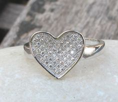 A lovely heart ring adorned with pave set crystals, makes a sweet gift. Wrapped in a box ready for gift giving.(r48) Heart measure 10mm x 13mm. *LIKE* us on Facebook http://www.facebook.com/Belesas to get 10%off coupon code, *FOLLOW* us on Twitter https://twitter.com/#!/Belesas to get more exclusive coupon codes *All item are ready to ship! Free shipping on orders over $150 using coupon code BELESAS150 ---------------------------------------------------- ENTER MY SHOP ► http://www.etsy.com/shop/ Cubic Zirconia Heart Ring For Mother's Day Gift, Mother's Day Gift Heart Ring With Cubic Zirconia, Mother's Day Gift Cubic Zirconia Heart Ring, Cubic Zirconia Heart Ring With Pave Setting For Wedding, Elegant Heart Ring With Pave Setting For Valentine's Day, Pave Setting Rings For Wedding On Valentine's Day, Heart Shaped Anniversary Ring With Pave Setting, Heart-shaped White Gold Diamond Ring Gift, Heart-shaped Pave Setting Wedding Ring