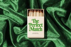 matches are in a match box on a green cloth with the words, the perfect match