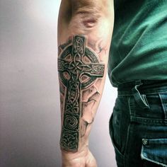 a man with a cross tattoo on his arm