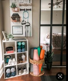 a room with several shelves filled with items and a mirror on the wall behind it