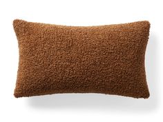 a brown pillow on a white background with no one in the room to see it