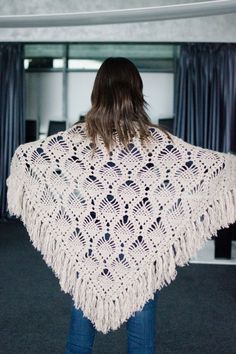 a woman wearing a white crocheted shawl