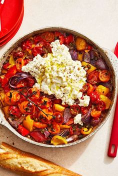 a pan filled with lots of different types of food on top of a white table