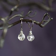 Small and delicate drop earrings with faceted rock crystal beads and pure titanium closures. The tiny beads at the top (above the rock crystal beads) are white topaze beads. Very simple and elegant minimalist design, easy to wear with any outfit. The rock crystal beads are about 8mm in diameter, they are transparent and shiny, and play with the light when they are moving. Total height: about 2cm including closure Bead diameter : 8mm The closures have been designed at the workshop and are handmad Tiny Beads, Rock Crystal, Sensitive Ears, Star Earrings, Little Gifts, The Rock, Crystal Beads, Jewelry Earrings Dangle, Dangle Drop Earrings