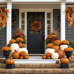 front porch decorated for fall with pumpkins and gourds