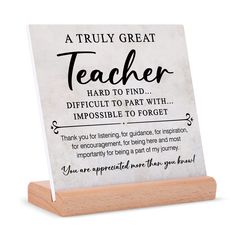 a wooden plaque that says, a truly great teacher