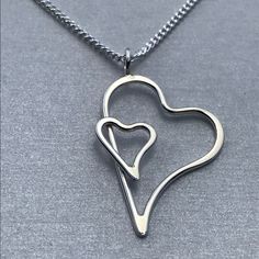 This pendant is made from two piece of 1.5 mm Sterling Silver wire and has been formed into these shapes before over lapping them and soldering together. As usual the solder is assay quality silver solder. The edges of parts of the hearts have been planished to make them wider and give a faceted effect which lets the light glint and shimmer. Simple and yet unusual. I can make it any size so if you want a smaller version just ask. Length 40 mm Width 30 mm This Sterling Silver Pendant comes with a Parts Of The Heart, Diy Wire Jewelry, Silver Jewelry Handmade, Metal Stamping, Silver Wire, Heart Pendant, Wire Jewelry, Sterling Silver Pendants, Heart Shapes