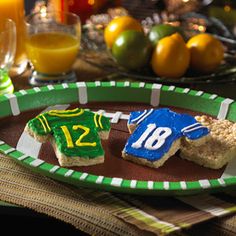 two pieces of food on a plate with oranges in the background and football jersey