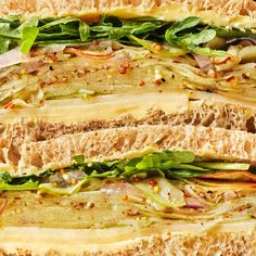 a large sandwich with meat, lettuce and other toppings on it's side