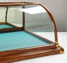 an old wooden mirror sitting on top of a blue tablecloth covered floor with gold trim around the edges