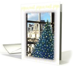 a card with a christmas tree in front of a window