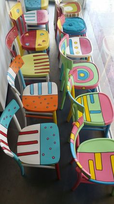 many colorful chairs are lined up on the floor