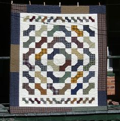 a quilt is hanging on a clothes line