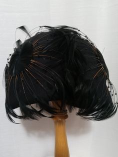 Vintage Black Rounded Feathered Hat. Stunning hat with all the razzle-dazzle. Black plumes affixed in circular bunches; extending from circular patches covered with short feathers. Tiny black beads on the Brown stems of some and a lovely rounded silhouette. Raised domed sections above each ear and back of head.  Tiny ribbon tracing the latter indicates back vs. front. Some feathers missing here and there, does not detract from its craftsmanship or beauty. By Mr. Charles. Sophisticated piece of adornment. Feathered Hat, Vintage Velvet Dress, Back Of Head, Holiday Skirts, Feather Hat, Razzle Dazzle, Blue Gown, Empire Waist Dress, Fabulous Dresses