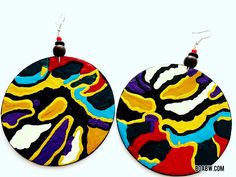 two circular earrings with colorful designs hanging from the ends of each earring, on a white background