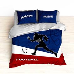 a bed with a football themed comforter and two pillow cases on top of it