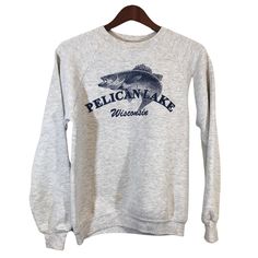 "PELICAN LAKE WISCONSIN Gay Fish Sweatshirt Size S ITEM DESCRIPTION: This sweatshirt will be perfect for all your outdoor activities. Material: 50% Cotton 50% Polyester Made in USA APPROXIMATE MEASUREMENTS: Pit To Pit: 19\" Sleeves: 27\" Length (neck to bottom): 22\" ITEM CONDITION: Vintage Condition (Small stain on the front low right side look at the last pic). ABOUT PELICAN LAKE: Pelican Lake offers some of Wisconsin's finest fishing and boating lakes. At 3,585 acres and a maximum depth of 39 Casual Sweatshirt With Letter Print For Outdoor Activities, Casual Sweatshirt With Letter Print For Outdoor, Casual Letter Print Sweatshirt For Outdoor Activities, Casual Tops For Outdoor Sports Season, Casual Tops For Outdoor Sports, Sporty Crew Neck Sweatshirt For Outdoor, Gray Crew Neck Top For Outdoor Activities, Gray Crew Neck Top For Outdoor, Casual Crew Neck Sweatshirt For Outdoor Activities