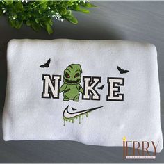 a white towel with the words nike and an image of a green alien on it