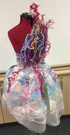 a dress made out of plastic and yarn