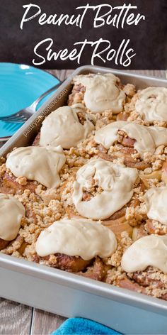 a pan filled with some kind of dessert on top of a wooden table next to blue plates