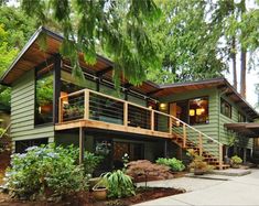 a green house surrounded by trees and plants