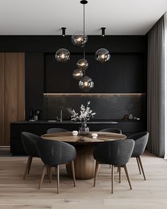 a modern dining room with black walls and wooden flooring, round table surrounded by gray chairs