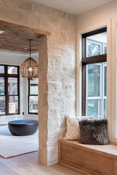 a living room filled with furniture next to two windows and a bowl on the window sill