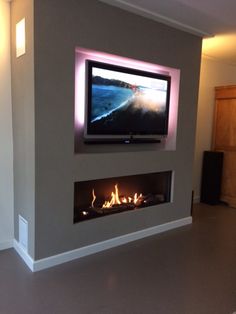 a flat screen tv mounted above a fire place