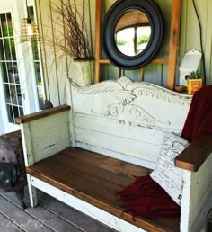 an old bench is sitting outside on the porch with a round window in the background