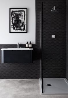 a black and white bathroom with a shower