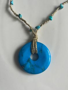 A vibrant turquoise coloured Howlite stone is suspended on a hand-plaited gold cord. Little turquoise beads are plaited into the cord. The necklace has a sliding knot, making the length adjustable and the necklace is finished off with two blue fluorite beads. This is a really versatile bit of jewellery that will bring some fun to your summer wardrobe. Gold Turquoise Adjustable Pendant Necklace, Adjustable Gold Turquoise Pendant Necklace, Gold Turquoise Pendant Necklace With Adjustable Chain, Turquoise Necklace With Adjustable Cord, Adjustable Turquoise Necklace With Cord, Adjustable Gold Turquoise Necklace With Round Beads, Gold Turquoise Necklace With Adjustable Chain, Gold Turquoise Necklace With Round Beads, Blue Beaded Jewelry With Adjustable Cord