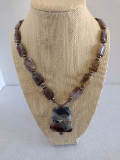 "This single strand OOAK necklace was made with Brownish Toned Botswana Agate Tablet Beads.  Spacers are Hematite Rondelles and Eggplant Seed Beads.  Pendant is a Faceted Trapezoid Botswana Agate accented Antique Silver Flowers.  Chain and Findings are Antique Silver Necklace - 21\" Extender 1 1/2\" Pendant is an additional 1 3/4\"" Antique Silver Necklace, Beads Pendant, Botswana Agate, Botswana, Silver Flowers, Chain Styles, Handcrafted Jewelry, Antique Silver, Seed Beads