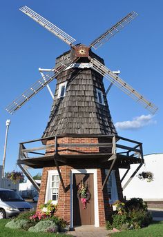 a windmill shaped building with a wreath on the door