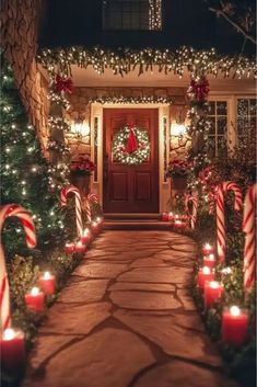 a house decorated for christmas with candy canes and lights on the front door,