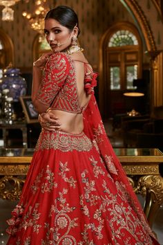 Editor's Note The scarlett red raw silk lehenga in this set is embellished with intricate gold and silk thread zardozi embroidery. The lehenga comes with two dupattas, one with a scalloped edge and the other with a thick border, and a fully embroidered choli. This set is perfect for a traditional and elegant bridal look. Color: Red Fabric: Raw silk Components: Lehenga, blouse and two dupattas Occasion: Wedding Disclaimer: Product color may slightly vary due to photographic lighting sources or yo Scarlett Red, Raw Silk Lehenga, Zardozi Embroidery, Silk Lehenga, Gold Silk, Silk Thread, Bridal Lehenga, Red Fabric, Raw Silk