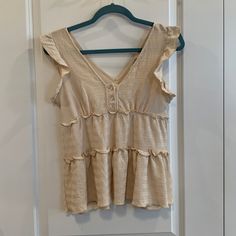 -Never Worn Casual Beige Top With Ruffles, Casual Beige Blouse With Ruffle Hem, Cream Cotton Ruffle Sleeve Tops, Cream Sleeveless Top With Ruffles, Fitted V-neck Tank Top With Ruffles, Cream V-neck Tops With Ruffles, Spring V-neck Tank Top With Ruffles, Ruffle Tank Top, Cream