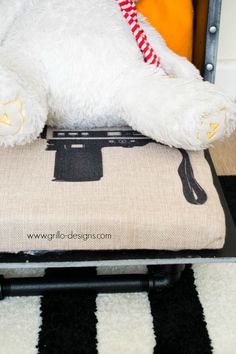 a white stuffed animal laying on top of a chair