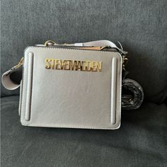 This Is A Very Hard To Find Limited Edition Steve Madden Bev. This Bag Is Sliver Metallic Bag With Gold Metallic Writing. This I Only Have 1 Available The Price Will Be Pretty High. Silver Shoulder Bag With Silver-tone Logo For Formal Events, Formal Silver Shoulder Bag With Logo Plaque, Luxury Shoulder Bag With Silver Accents For Formal Occasions, Metallic Silver Evening Bag With Logo Plaque, Luxury Formal Shoulder Bag With Silver Accents, Silver Evening Bag With Metal Logo, Rectangular Shoulder Bag With Silver Accents, Silver Shoulder Bag With Silver-tone Logo For Formal Occasions, Elegant Silver Bags With Metal Logo