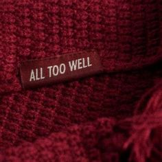 a label on a red sweater that says, all too well