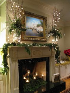 a living room decorated for christmas with candles and greenery on the fireplace mantel