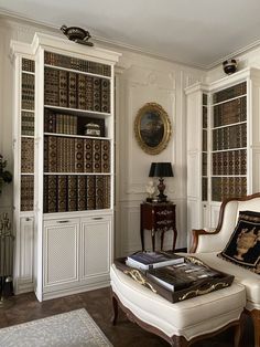 a living room filled with furniture and bookshelves