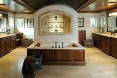 a large bathroom with two sinks and a jacuzzi tub in the middle of it