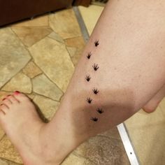 a person with small black flowers on their leg