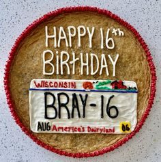 a happy 16th birthday cake with the license plate for braay - 16