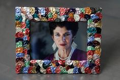 a multicolored photo frame with a woman's face in the center and pearls on it