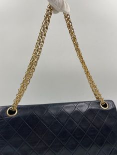 This vintage Classic Chanel Flap bag is crafted from diamond quilted black lambskin leather with 24k gold-plated hardware and a convertible reissue chain shoulder strap. There is a single exterior patch pocket on the back, a single zip pocket under the front flap and three interior compartments. Inside the bag is lined with maroon leather. The longest chain drop for this bag is 35cm and the chain doubled and at its shortest is 20cm. This bag is in good vintage condition with some signs of use. There are some minor wrinkles to some parts of the leather and some colour fade to the gold plated hardware. The hallmark on the CC turn lock confirms the gold hardware is plated in 24K gold, a real collectors item. Before 2008, Chanel Classic Flaps with gold coloured hardware (chains, clasps, gromme Classic Quilted Flap Bag For Everyday Use, Classic Flap Bag With Chain Strap, Vintage Black Quilted Shoulder Bag, Classic Rectangular Shoulder Bag With Diamond Quilting, Classic Evening Shoulder Bag With Diamond Quilting, Classic Diamond Quilted Shoulder Bag For Evening, Classic Double Flap Bag With Chain Strap, Timeless Quilted Double Flap Bag, Vintage Quilted Evening Bag