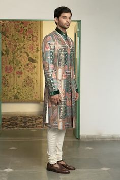 Emerald green sherwani with floral and geometric motifs in a mosaic patterned base, highlighted by placed embroidery. Comes with inner kurta and churidar. - Aza Fashions Designer Green Kurta For Festive Occasions, Designer Festive Pista Green Sets, Green Bandhgala With Naqshi For Festivals, Fitted Green Bandhgala With Naqshi Detailing, Fitted Green Bandhgala With Naqshi, Pista Green Kurta For Reception With Traditional Drape, Festive Green Bandhgala With Naqshi Detailing, Festive Green Bandhgala With Naqshi, Traditional Kurta With Meenakari